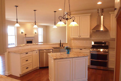 Inspiration for a mid-sized transitional l-shaped medium tone wood floor and brown floor open concept kitchen remodel in Other with a farmhouse sink, raised-panel cabinets, white cabinets, granite countertops, beige backsplash, subway tile backsplash, stainless steel appliances, an island and brown countertops