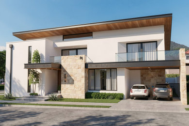 Example of a large trendy beige two-story house exterior design in Other with a clipped gable roof, a metal roof and a white roof