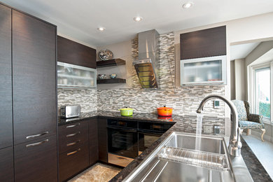 Inspiration for a large contemporary l-shaped marble floor and beige floor eat-in kitchen remodel in Toronto with a drop-in sink, flat-panel cabinets, dark wood cabinets, marble countertops, gray backsplash, glass tile backsplash, stainless steel appliances and a peninsula