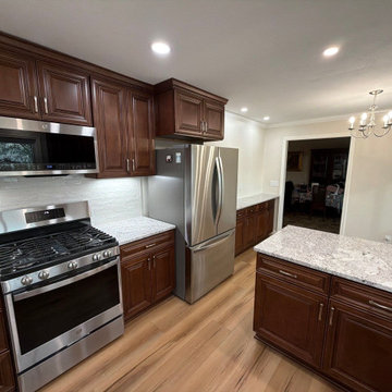USCD cabinetry accompanied granite countertops, porcelain tile backsplash and Ca