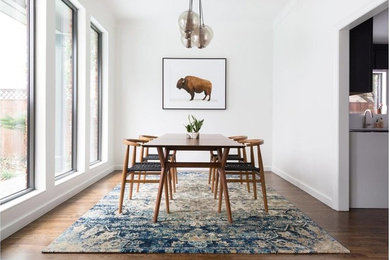 Example of a mid-sized trendy dark wood floor enclosed dining room design in Other with white walls and no fireplace