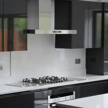 Sleek Modern Black Kitchen with Island by Kudos Interior Design