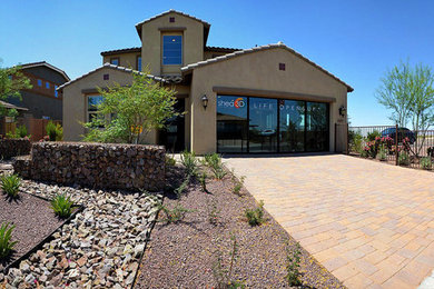 Design ideas for a mid-sized modern two-storey stucco beige exterior in Phoenix.