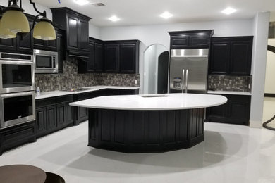Kitchen - modern kitchen idea in Austin with gray backsplash and stainless steel appliances