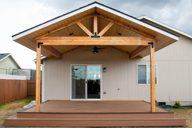 Inspiration for a mid-sized backyard deck remodel in Other with a roof extension