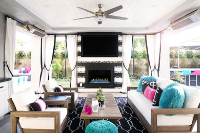 Example of a mid-sized transitional backyard tile patio design in Orange County with a roof extension