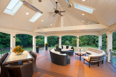 Design ideas for a large traditional backyard verandah in DC Metro with a roof extension.