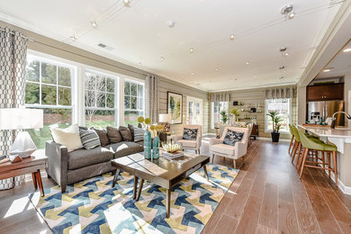 Mid-sized transitional open concept medium tone wood floor living room photo in Charlotte with beige walls