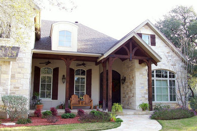 Inspiration for a large timeless beige two-story mixed siding exterior home remodel in Austin with a hip roof