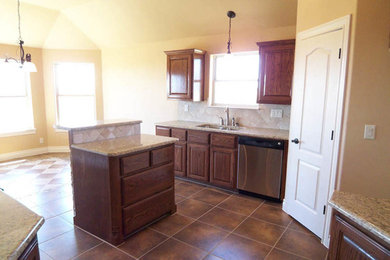 Large ceramic tile kitchen photo in Austin with granite countertops and an island