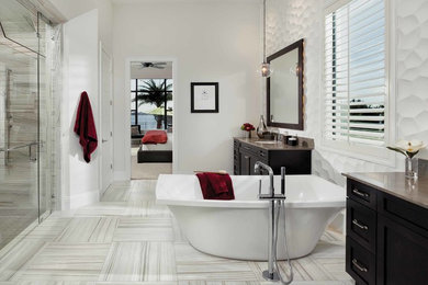 Example of a mid-sized transitional master beige tile, gray tile, white tile and stone slab porcelain tile bathroom design in Orlando with shaker cabinets, dark wood cabinets, a one-piece toilet, white walls and an undermount sink