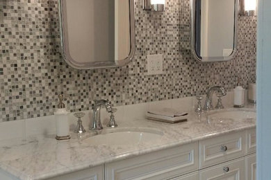 Inspiration for a mid-sized transitional master bathroom in New York with raised-panel cabinets, white cabinets, an alcove tub, a shower/bathtub combo, black and white tile, gray tile, mosaic tile, multi-coloured walls, marble floors, an undermount sink, marble benchtops, grey floor and a sliding shower screen.
