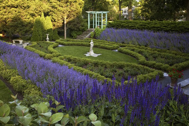 Inspiration for a large traditional backyard formal garden in Chicago with with flowerbed.