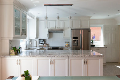 Inspiration for a mid-sized contemporary porcelain tile and multicolored floor eat-in kitchen remodel in Toronto with a drop-in sink, white cabinets, granite countertops, white backsplash, ceramic backsplash, stainless steel appliances, an island and gray countertops