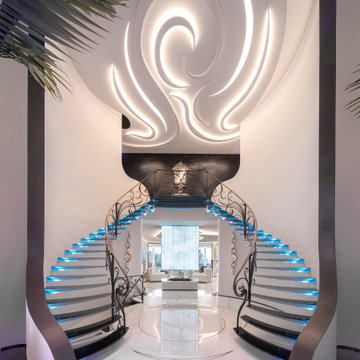 Amazing floating staircase with cantileverd glass treads and artistic balustrade