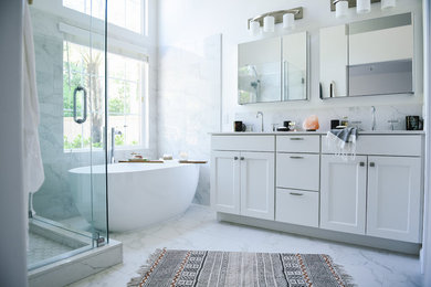 Large transitional master white tile and porcelain tile porcelain tile and white floor bathroom photo in San Diego with shaker cabinets, white cabinets, a two-piece toilet, white walls, an undermount sink, quartz countertops, a hinged shower door and white countertops
