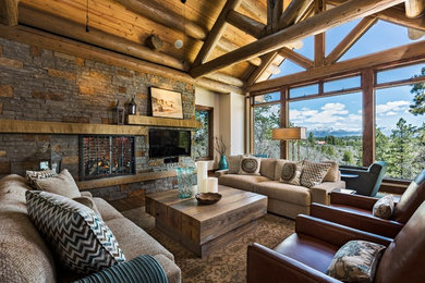 Living room - rustic medium tone wood floor living room idea in Denver with beige walls, a standard fireplace, a stone fireplace and a wall-mounted tv