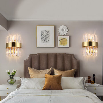 Pair of gold crystal wall sconces flanking a headboard — Mirodemi