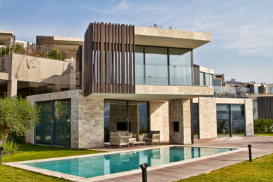 Inspiration for a medium sized and black modern two floor detached house in Other with wood cladding and a flat roof.