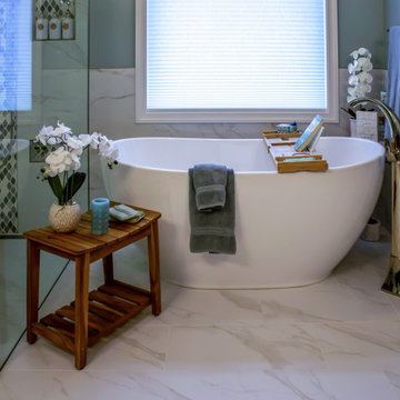 Primary Bath with Marble Look Tiled Shower and Free Standing Tub