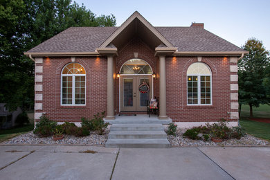 Traditional one-storey brick house exterior in Kansas City with a gable roof and a shingle roof.