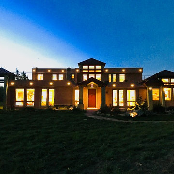 Light glows from inside and out from the front of the home.