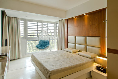 This is an example of a mid-sized contemporary master bedroom in Bengaluru with white walls and marble floors.