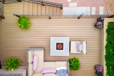 Example of a mid-sized classic backyard patio design in Other with a fire pit