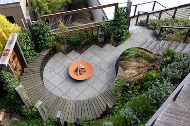 Photo of a small and australian native contemporary courtyard full sun formal garden for summer in Melbourne with concrete pavers.