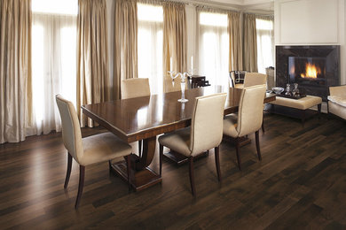 Enclosed dining room - large transitional dark wood floor enclosed dining room idea in New York with white walls, a standard fireplace and a stone fireplace