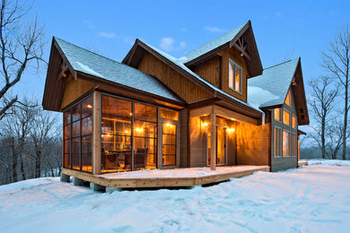 Large contemporary brown two-story wood gable roof idea in Vancouver