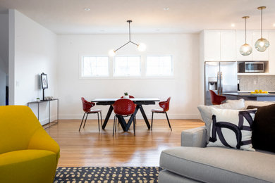 Small 1960s open concept light wood floor family room photo in New York with white walls