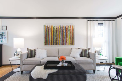 Example of a trendy light wood floor family room design in Columbus with white walls