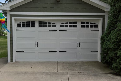 Photo of a mid-sized transitional detached two-car garage in Chicago.