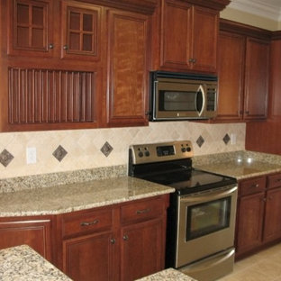 Small traditional kitchen pantry inspiration - Kitchen pantry - small traditional single-wall ceramic floor kitchen pantry idea in Louisville with flat-panel cabinets, medium tone wood cabinets, granite countertops, beige backsplash, stone tile backsplash and stainless steel appliances