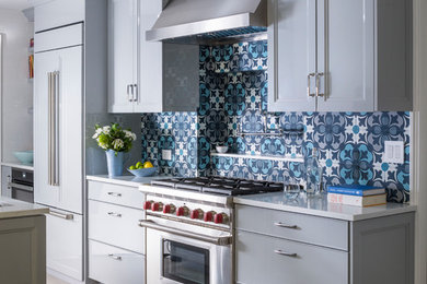 Mid-sized trendy galley ceramic tile enclosed kitchen photo in New York with an undermount sink, shaker cabinets, gray cabinets, quartz countertops, ceramic backsplash, stainless steel appliances and white countertops