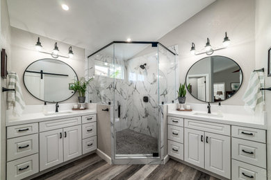 Mid-sized farmhouse master vinyl floor and single-sink bathroom photo in San Diego with shaker cabinets, white cabinets, a two-piece toilet, white walls, an undermount sink, white countertops and a built-in vanity