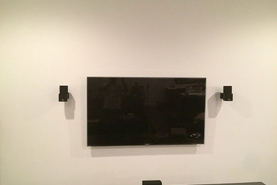 Inspiration for a transitional living room remodel in Vancouver with beige walls and a wall-mounted tv