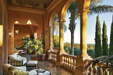 Inspiration for a mediterranean balcony remodel in Los Angeles with a roof extension