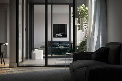 Photo of a small modern master bedroom in Brisbane with grey walls and light hardwood floors.