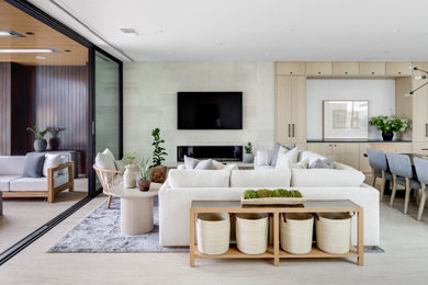 Inspiration for a large contemporary open concept porcelain tile and beige floor living room remodel in Orange County with white walls, a ribbon fireplace, a stone fireplace and a wall-mounted tv