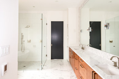 Photo of a mid-sized traditional master bathroom in Dallas with flat-panel cabinets, light wood cabinets, a corner tub, an open shower, a one-piece toilet, gray tile, white tile, marble, white walls, a drop-in sink, marble benchtops and an open shower.