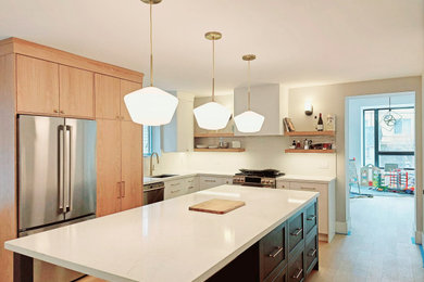 Kitchen - contemporary l-shaped light wood floor and beige floor kitchen idea with a drop-in sink, flat-panel cabinets, white cabinets, ceramic backsplash, stainless steel appliances, an island and white countertops
