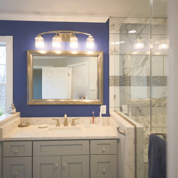 Master bathroom remodel in Poquoson with corner bathtub & marble lined tiles