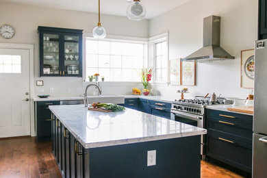 Inspiration for a transitional medium tone wood floor kitchen remodel in Phoenix with a farmhouse sink, shaker cabinets, blue cabinets, marble countertops, stainless steel appliances and an island