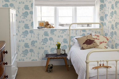 This is an example of a mid-sized contemporary nursery for boys in Other with white walls and carpet.