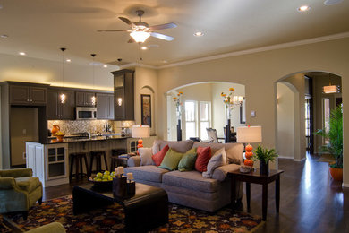 Example of a classic dark wood floor living room design in Oklahoma City with beige walls, a standard fireplace and a stone fireplace