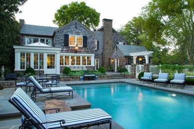 Pool fountain - large traditional backyard stone and rectangular lap pool fountain idea in Other