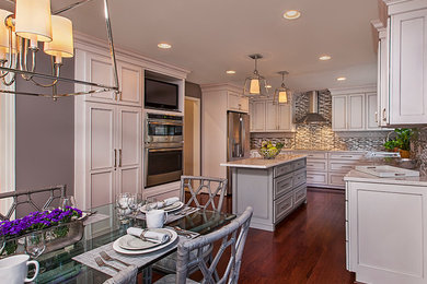 Inspiration for a large transitional u-shaped dark wood floor and brown floor eat-in kitchen remodel in Detroit with beaded inset cabinets, white cabinets, quartzite countertops, gray backsplash, glass tile backsplash, stainless steel appliances and an island
