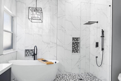 Inspiration for a mid-sized modern master marble tile laminate floor and beige floor bathroom remodel in Dallas with a built-in vanity, white walls, a hinged shower door and a niche